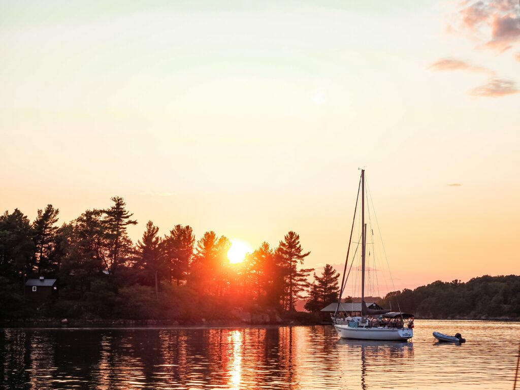 A sailboat on the St. Lawrence River at sunset.